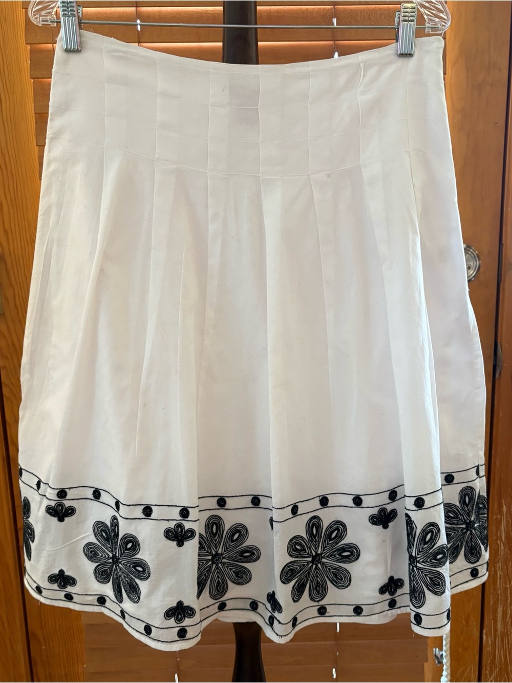 Sunny Leigh White Box-Pleated Skirt with Black Floral Embroidery